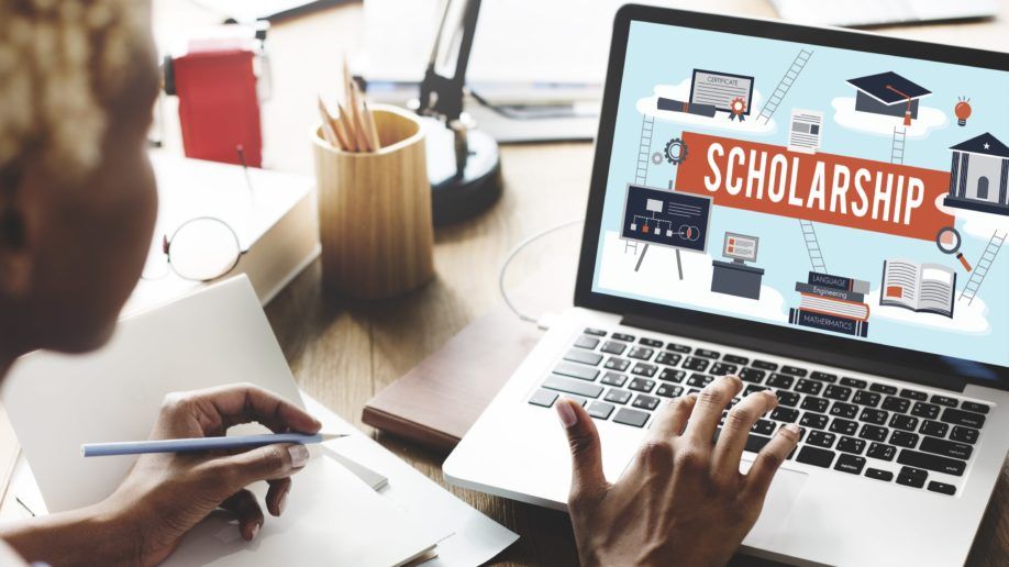 Student searching for MP scholarship on a laptop